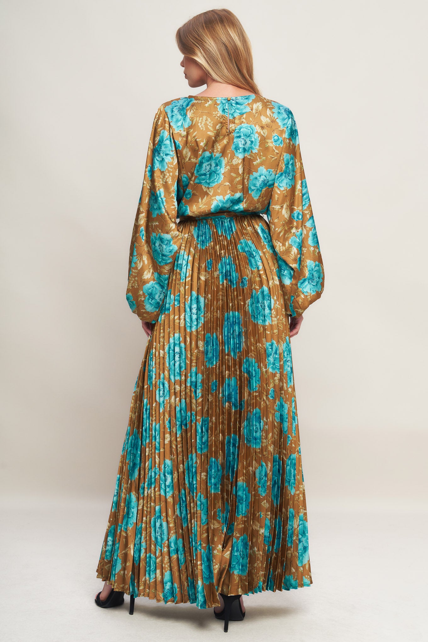 A printed woven satin maxi dress featuring round neckline, long sleeve, elasticized waist with pleated skirt and back button closure