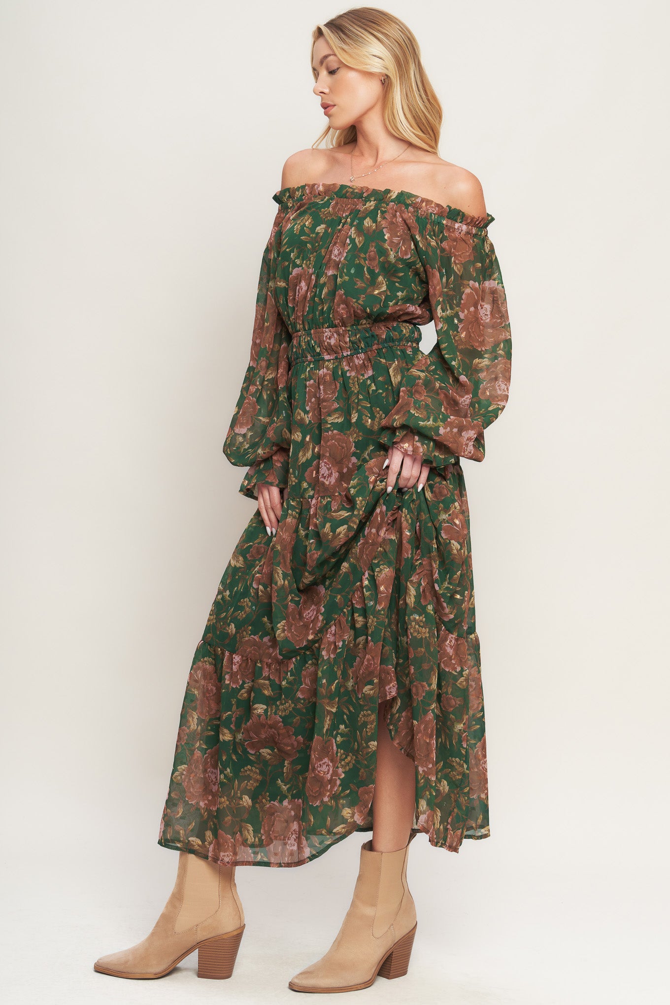 A printed woven midi dress featuring elasticized wide ruffled neckline, long sleeve with ruffled cuff, elasticized waist and tiered skirt