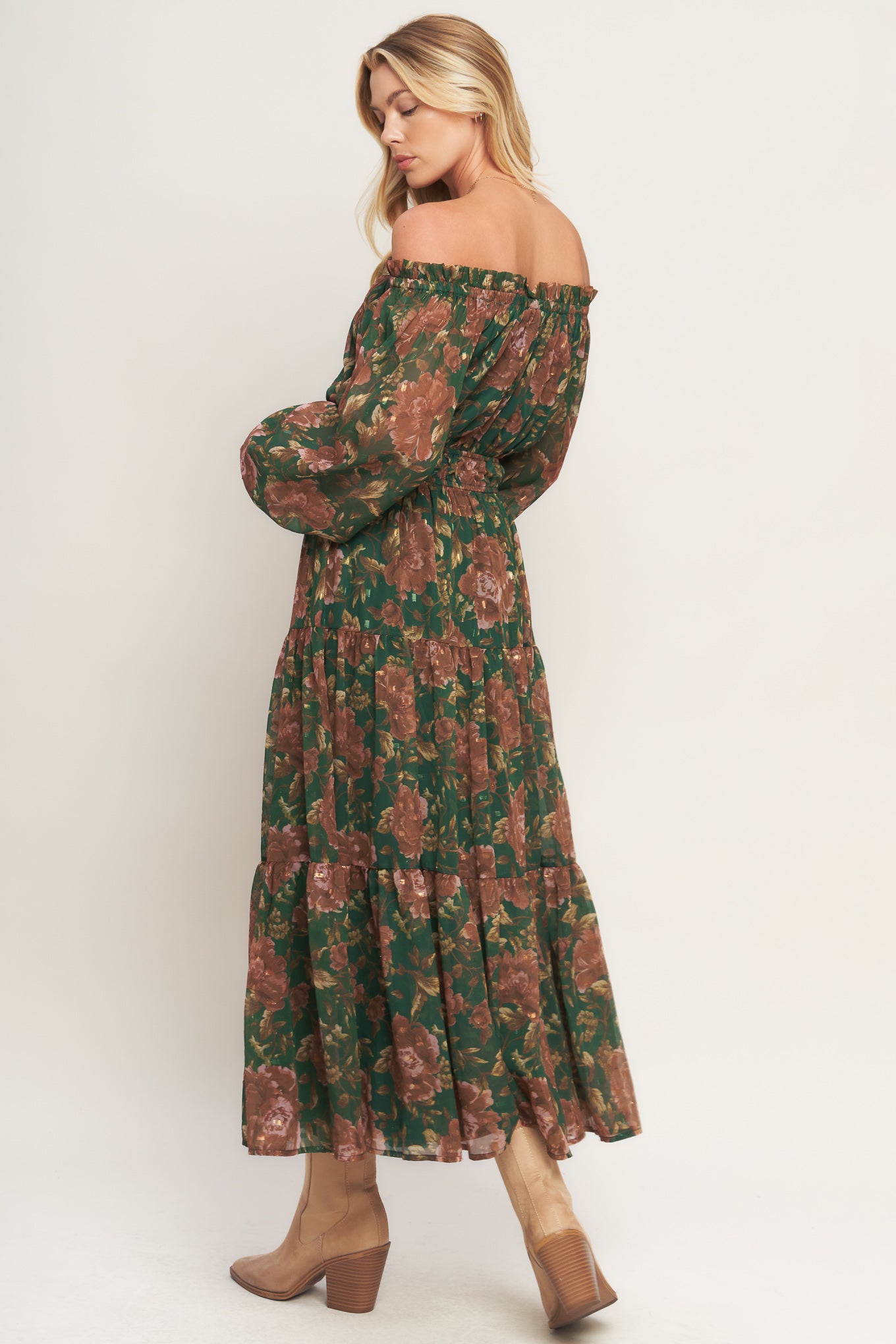 A printed woven midi dress featuring elasticized wide ruffled neckline, long sleeve with ruffled cuff, elasticized waist and tiered skirt