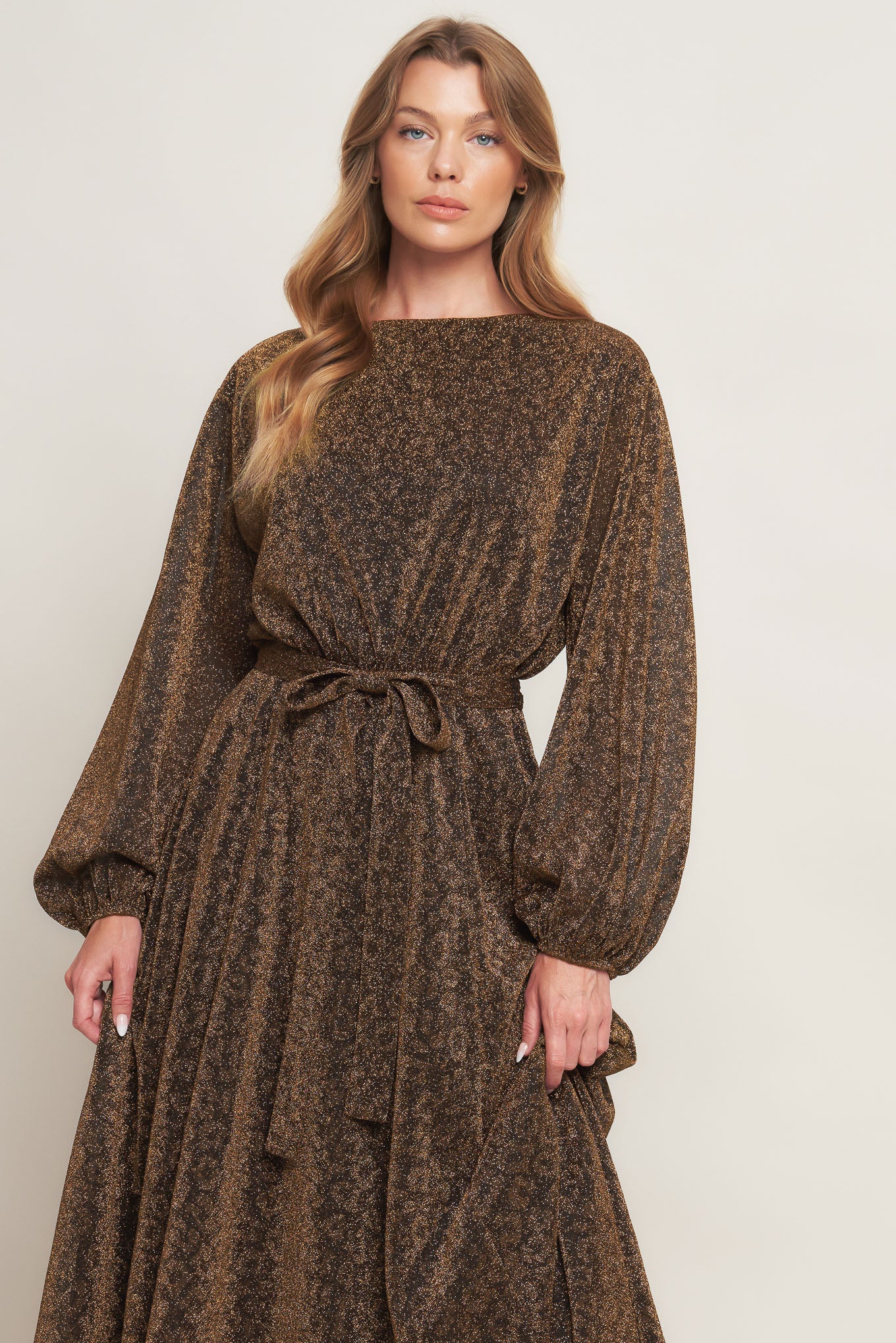 A metallic threaded woven midi dress featuring wide neckline, long blouson sleeve, self sash tie and back zipper closure