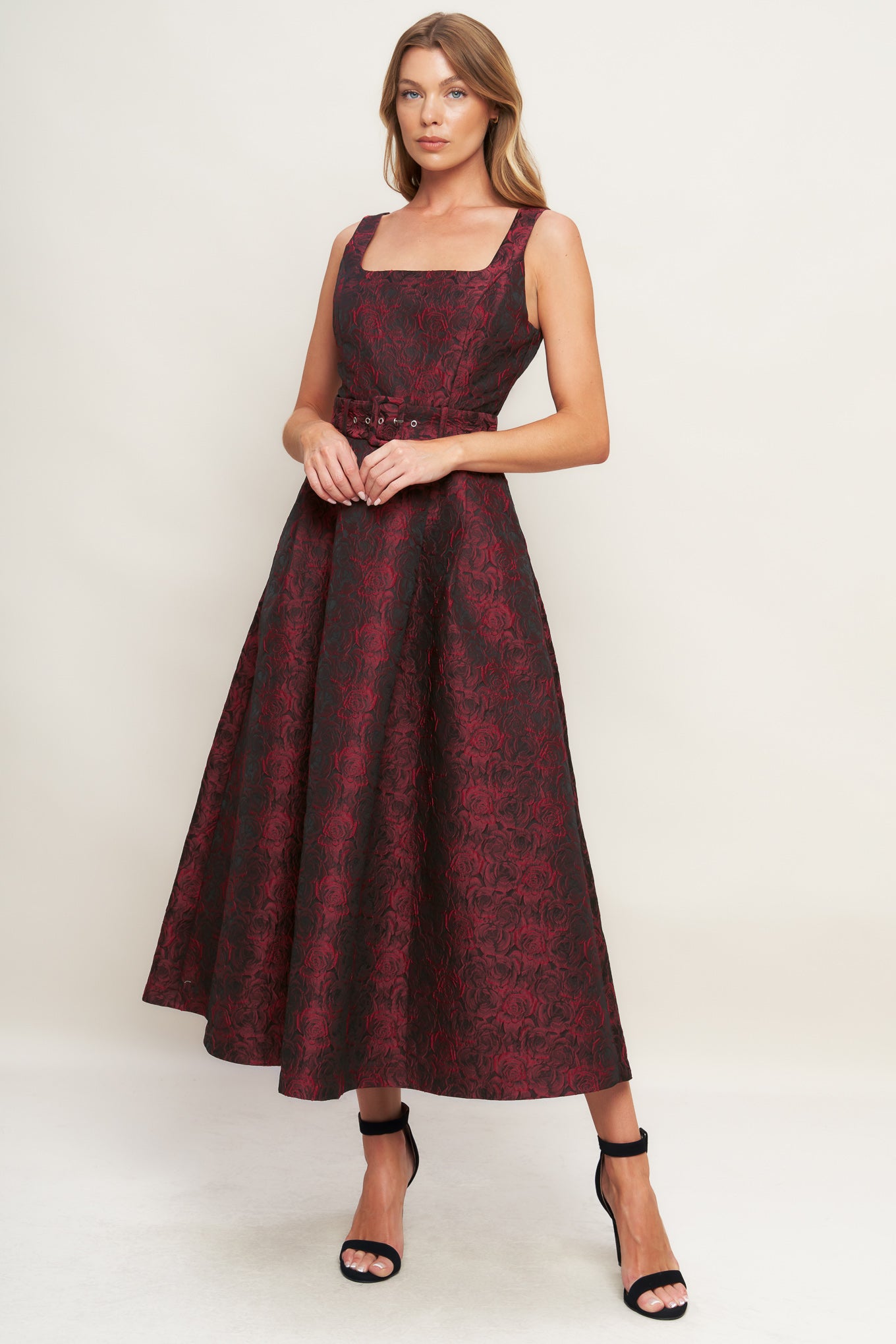 A woven jacquard midi dress featuring square neckline, sleeveless, self belt, full skirt and back zipper closure