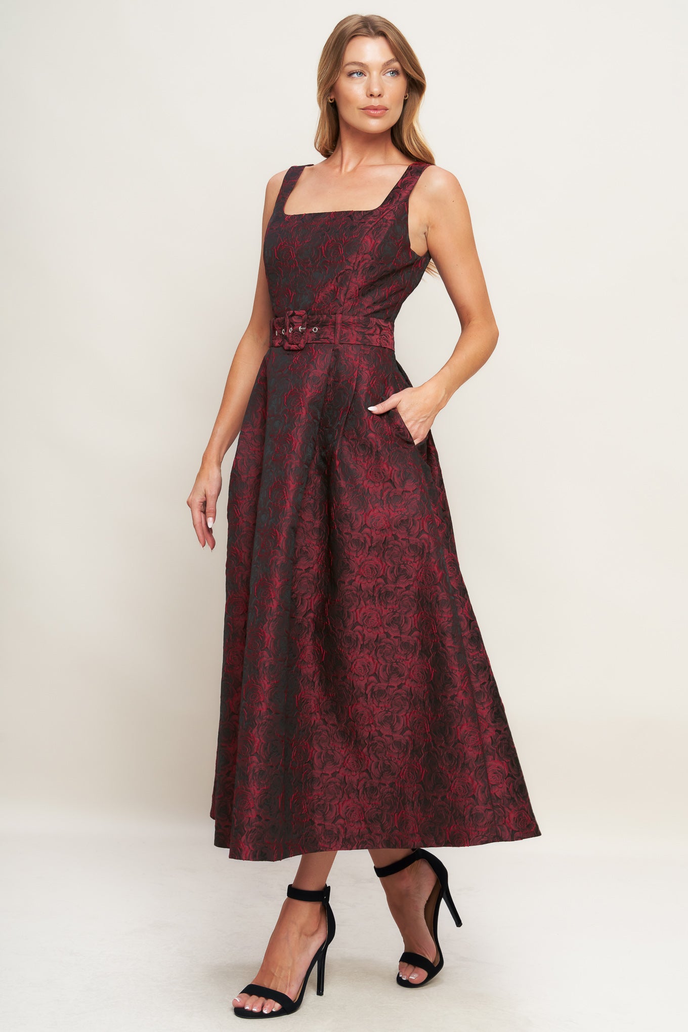 A woven jacquard midi dress featuring square neckline, sleeveless, self belt, full skirt and back zipper closure