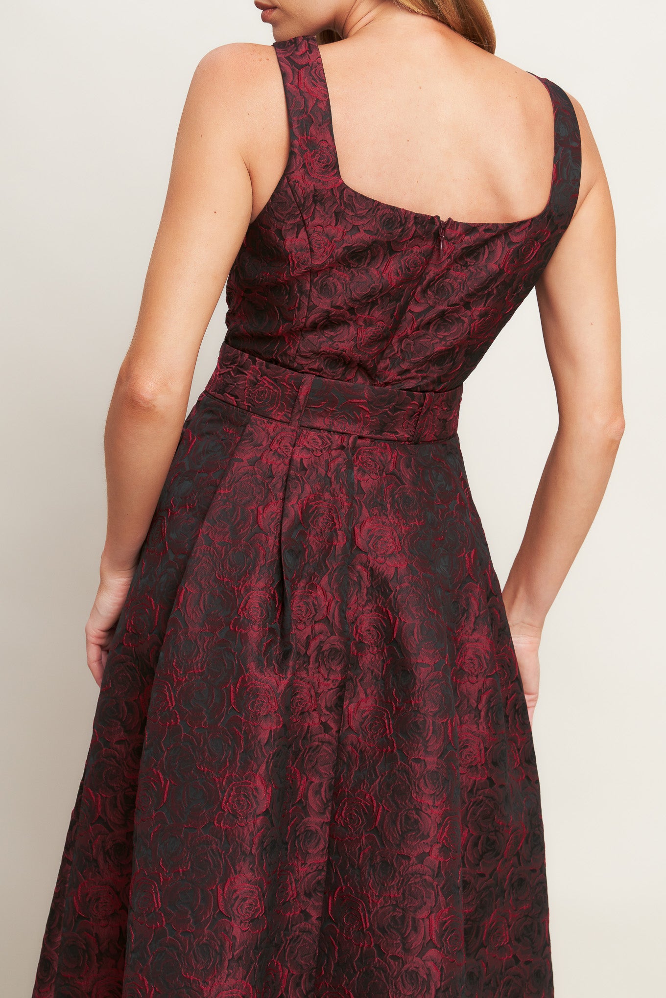 A woven jacquard midi dress featuring square neckline, sleeveless, self belt, full skirt and back zipper closure