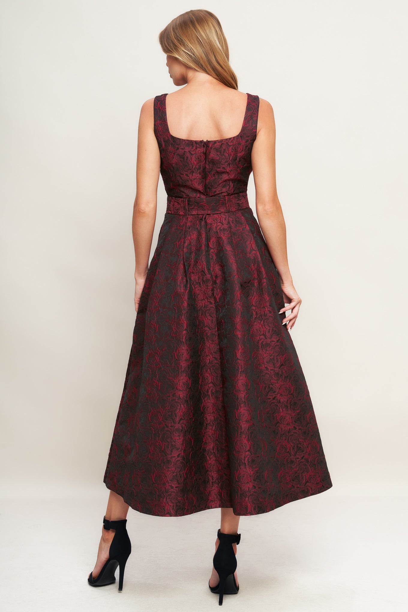 A woven jacquard midi dress featuring square neckline, sleeveless, self belt, full skirt and back zipper closure