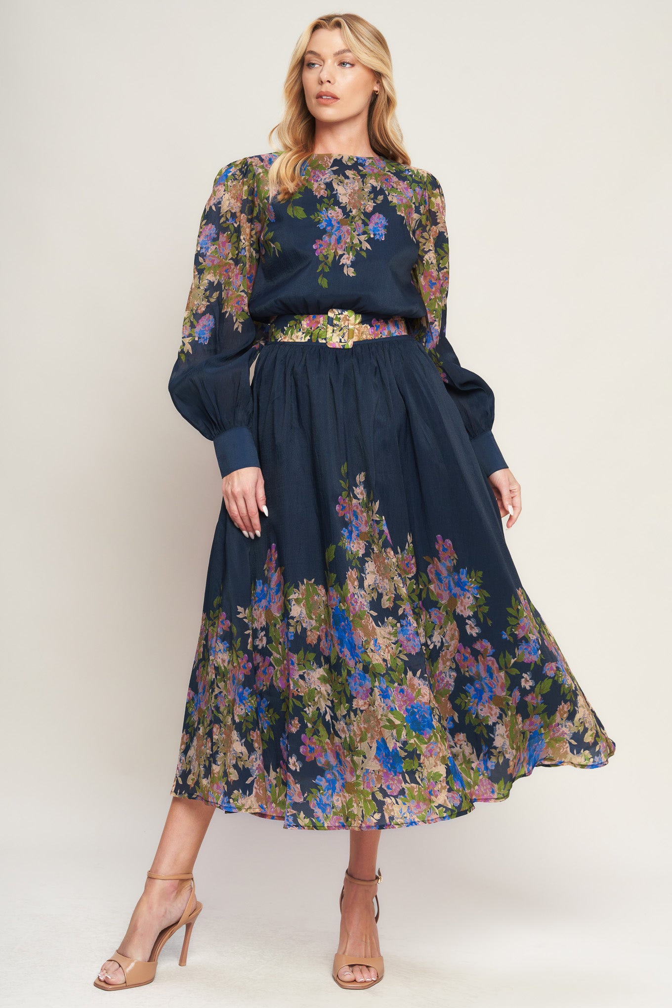 A printed woven midi dress featuring round neckline, long sleeve with wide cuff, waist band, full skirt and back zipper closure