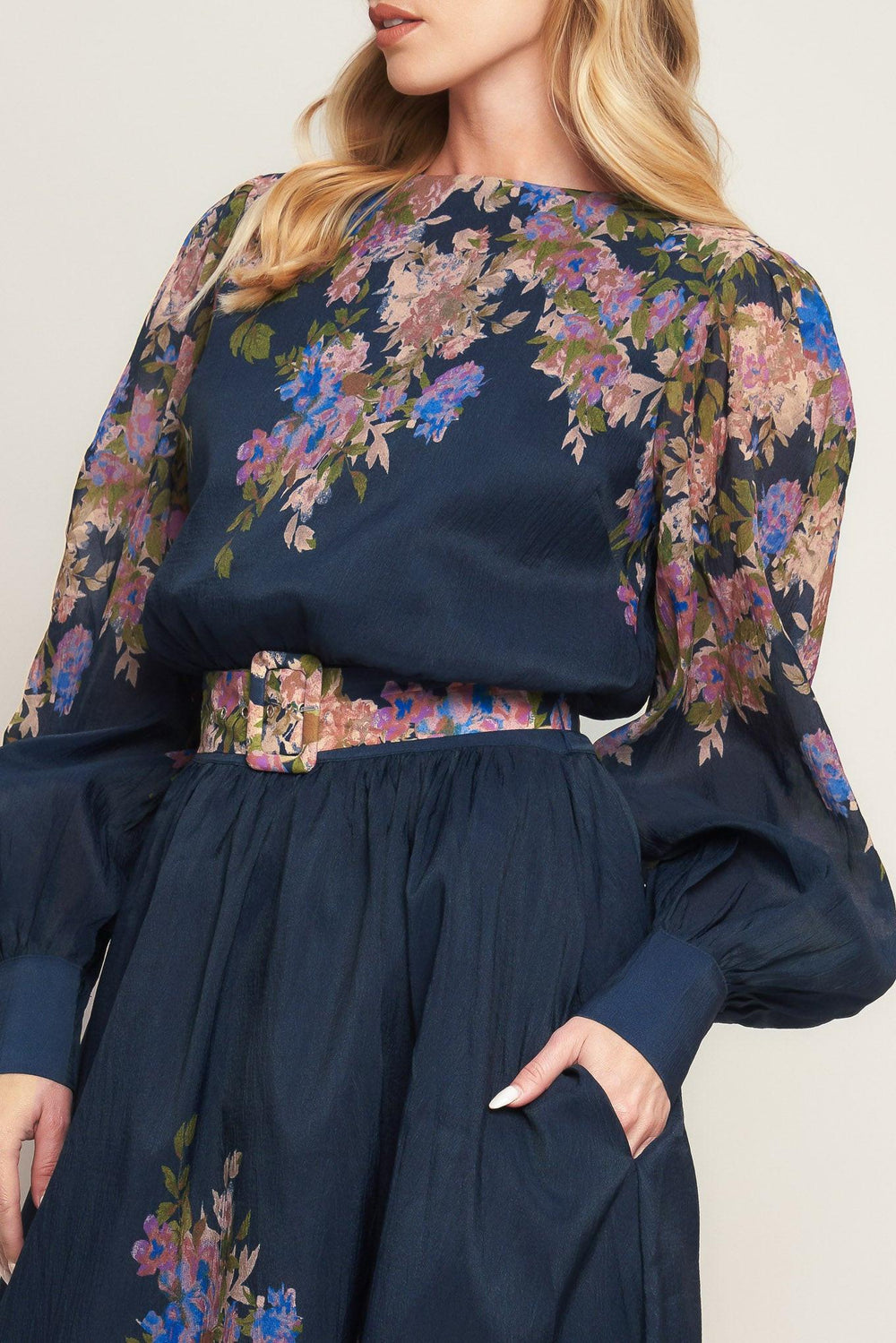 A printed woven midi dress featuring round neckline, long sleeve with wide cuff, waist band, full skirt and back zipper closure