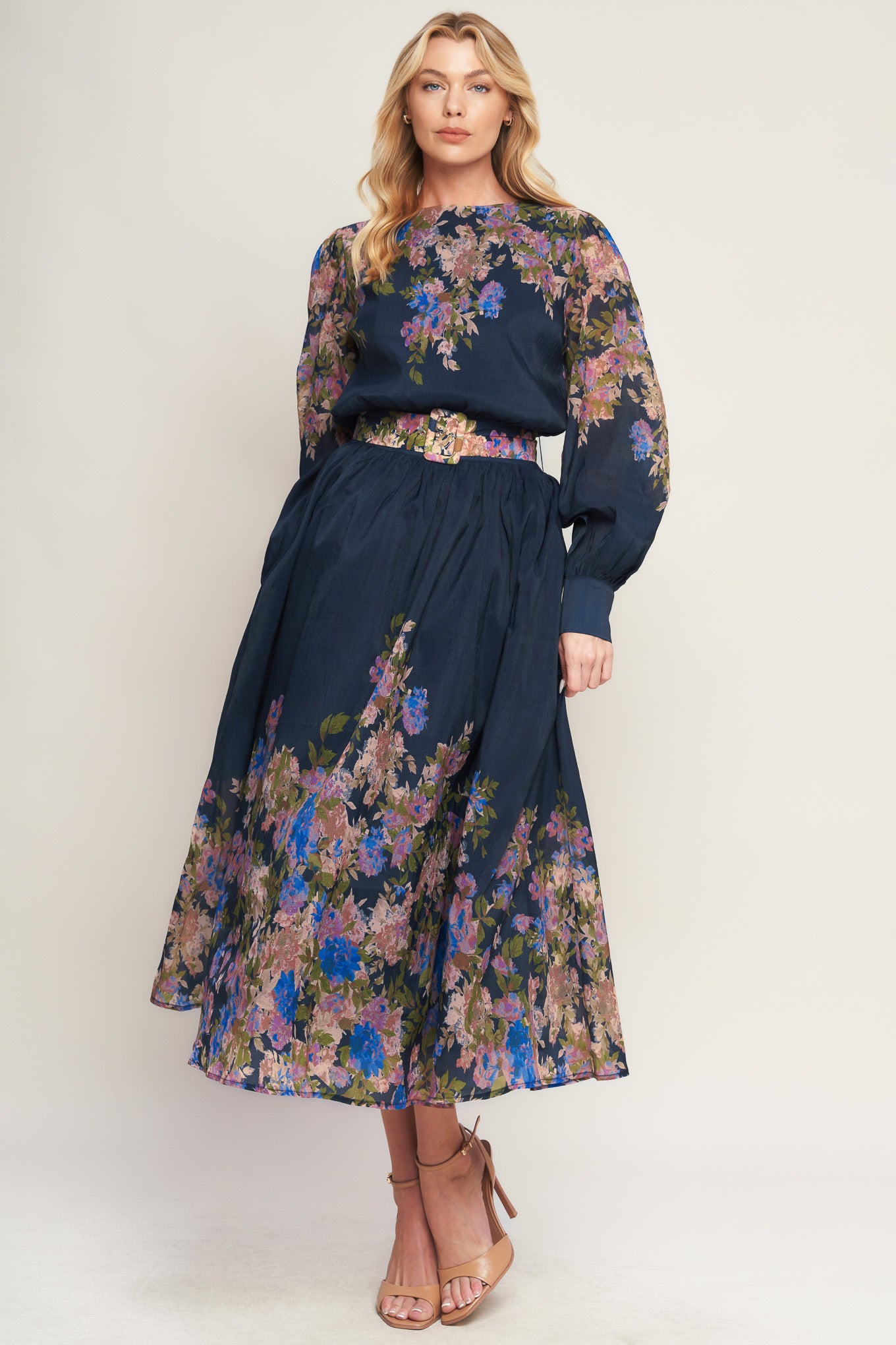A printed woven midi dress featuring round neckline, long sleeve with wide cuff, waist band, full skirt and back zipper closure