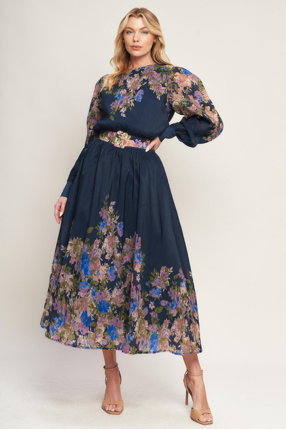 A printed woven midi dress featuring round neckline, long sleeve with wide cuff, waist band, full skirt and back zipper closure