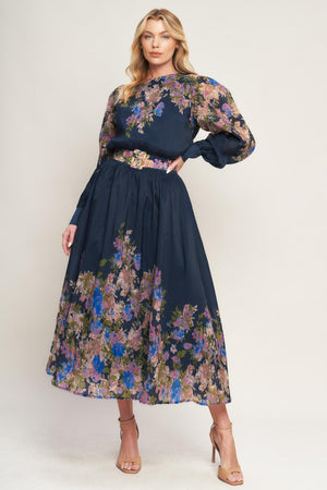 A printed woven midi dress featuring round neckline, long sleeve with wide cuff, waist band, full skirt and back zipper closure