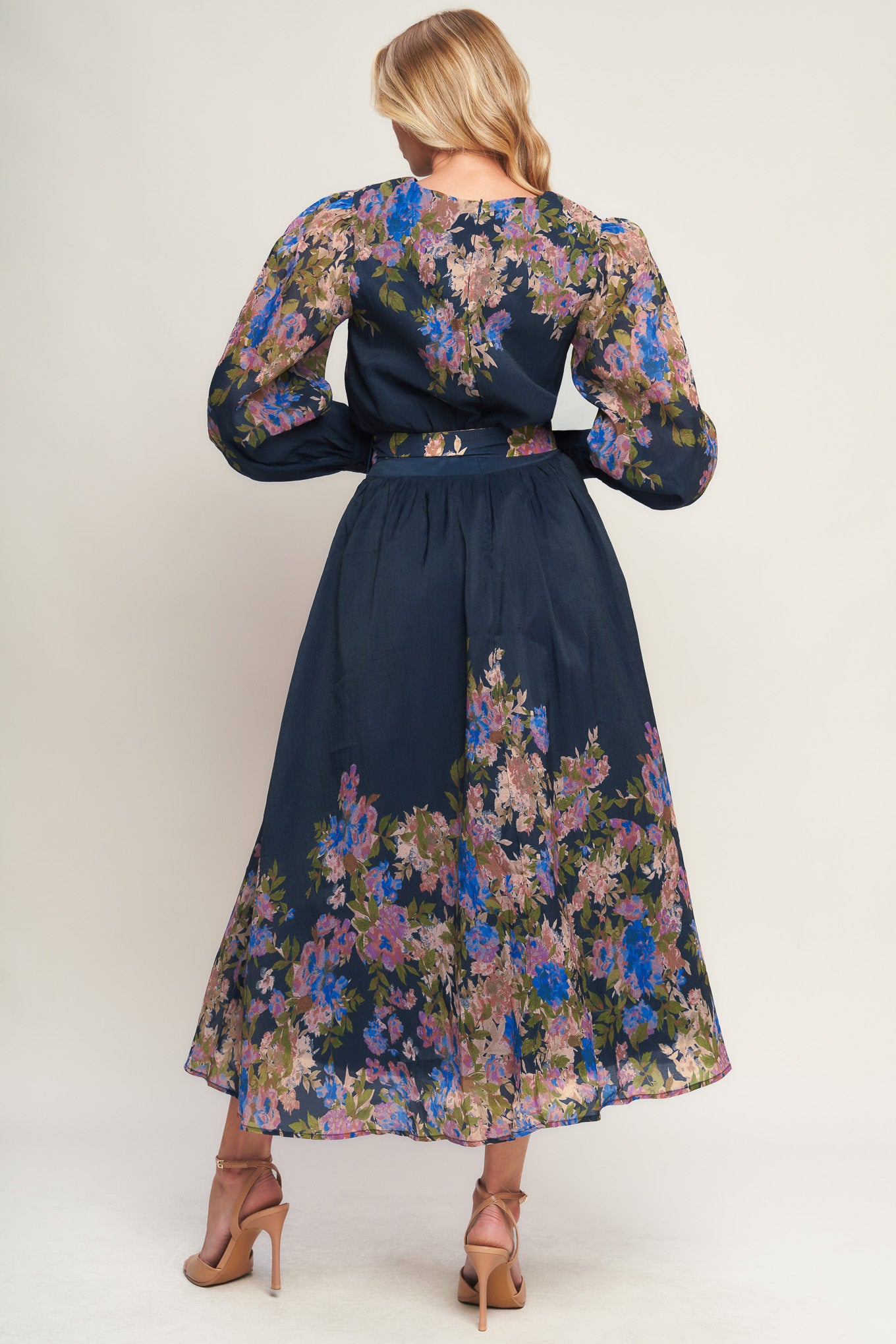A printed woven midi dress featuring round neckline, long sleeve with wide cuff, waist band, full skirt and back zipper closure