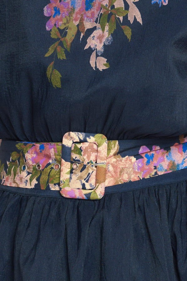 A printed woven midi dress featuring round neckline, long sleeve with wide cuff, waist band, full skirt and back zipper closure