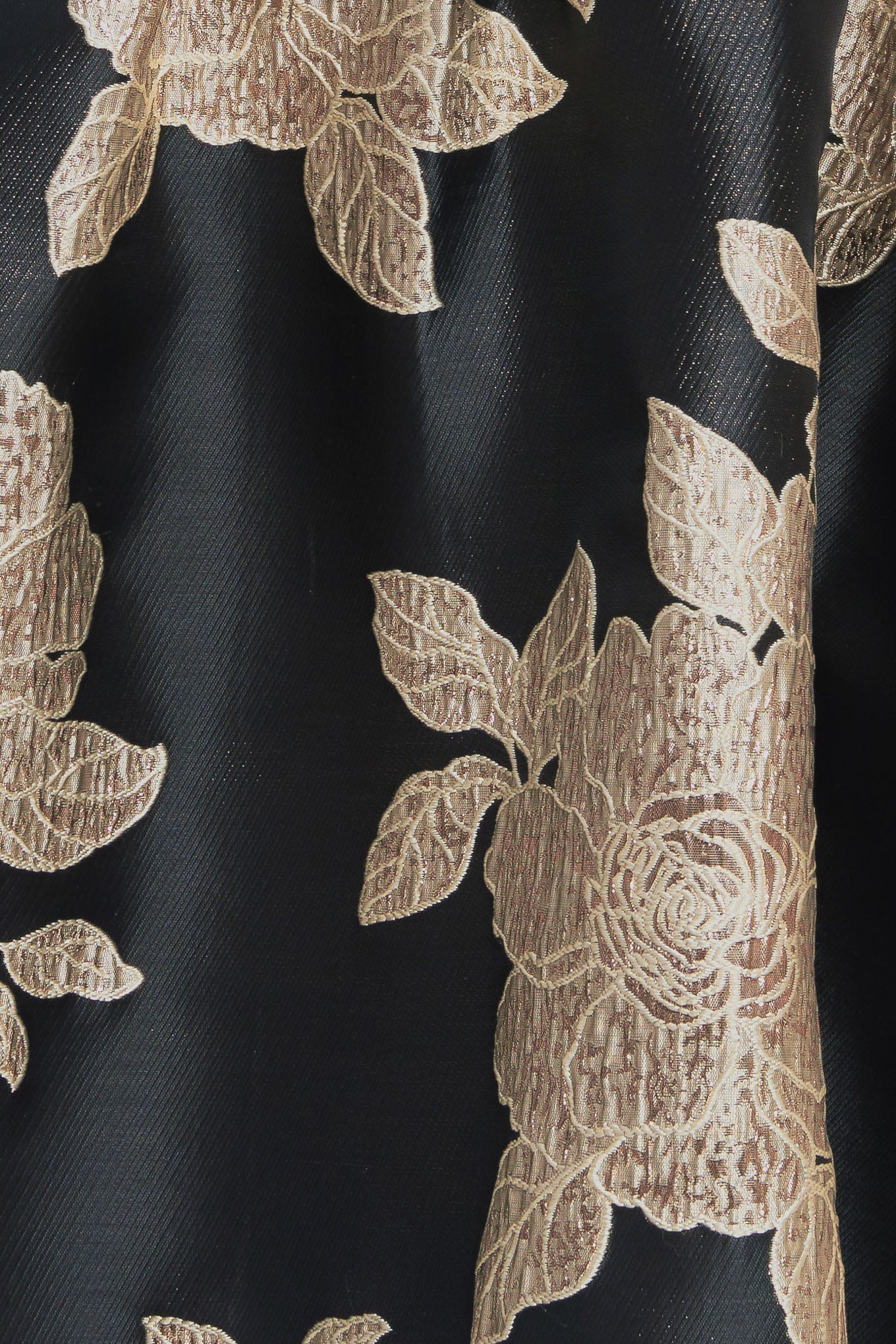 A textured woven mini dress featuring wide neckline, sleeveless, shoulder bow detail, full skirt and back zipper closure