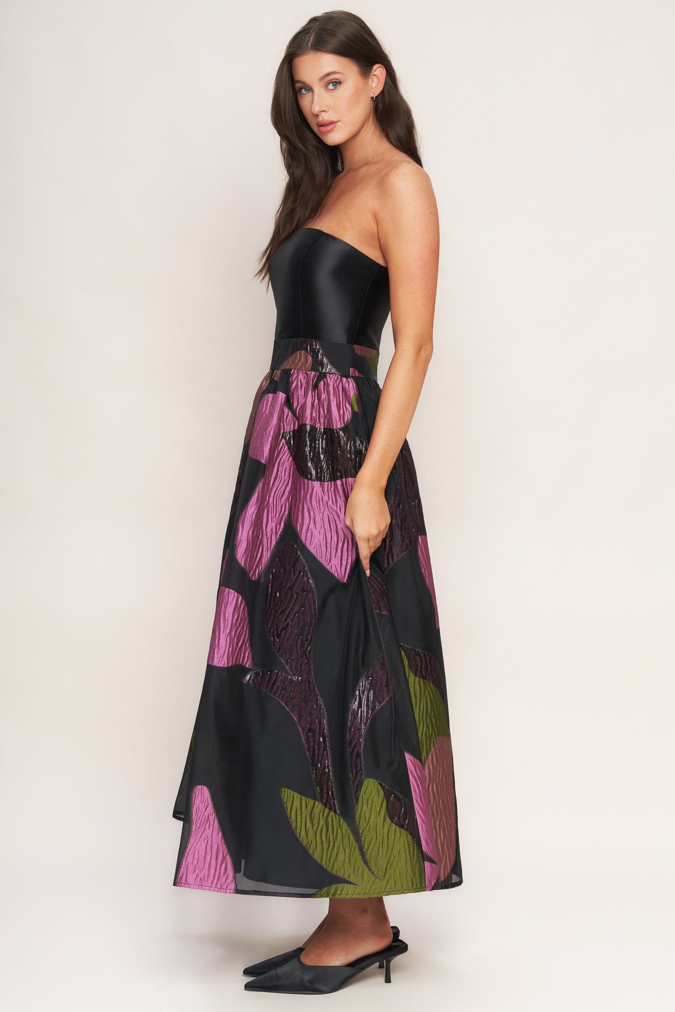 A solid and printed woven midi dress featuring solid tube top, printed full skirt and back zipper closure