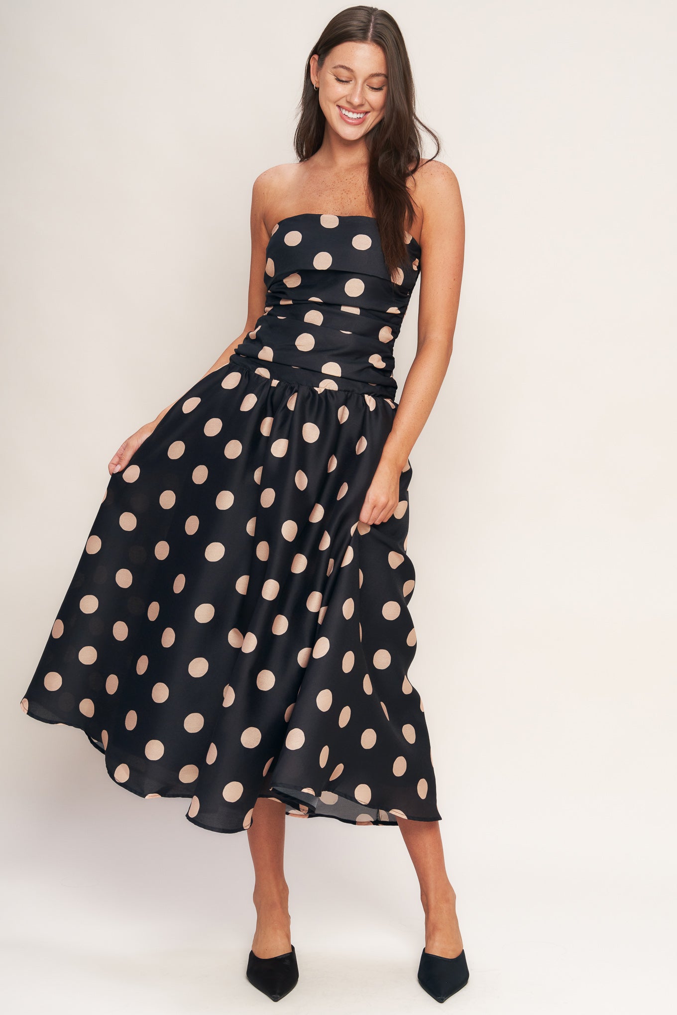 A printed woven midi dress featuring strapless, side shirred bodice, drop waistline, full skirt and smocked back bodice