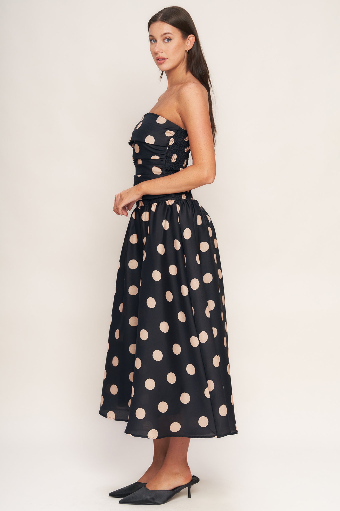 A printed woven midi dress featuring strapless, side shirred bodice, drop waistline, full skirt and smocked back bodice