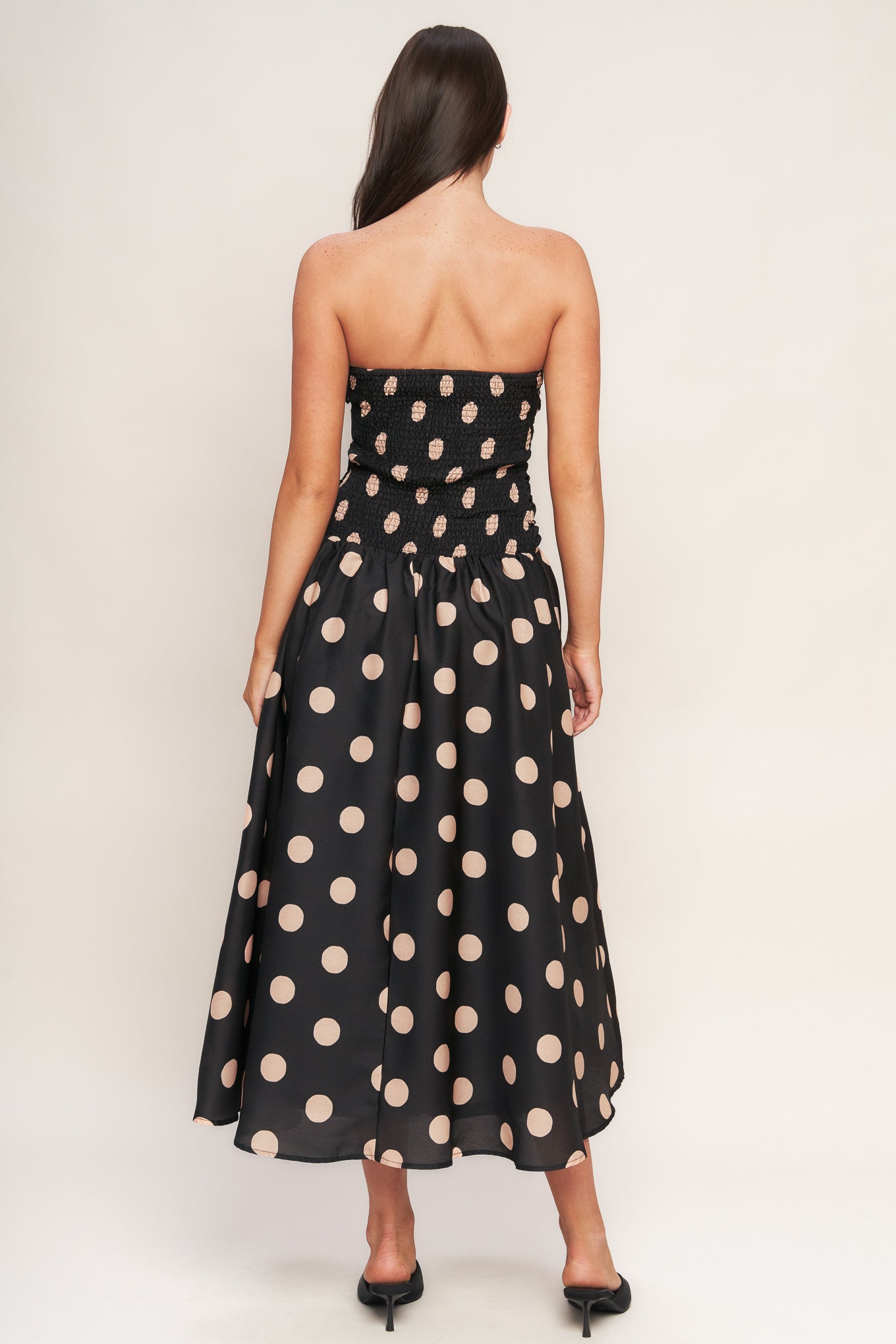 A printed woven midi dress featuring strapless, side shirred bodice, drop waistline, full skirt and smocked back bodice
