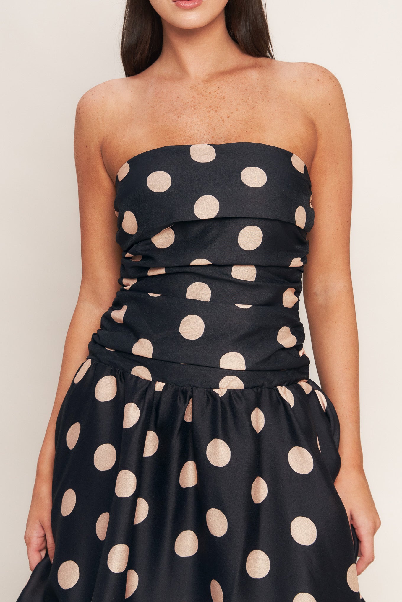 A printed woven midi dress featuring strapless, side shirred bodice, drop waistline, full skirt and smocked back bodice