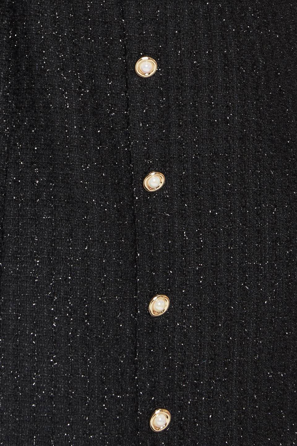 A tweed mini dress featuring trimmed straight neckline, straps, front button down detail and back zipper closure