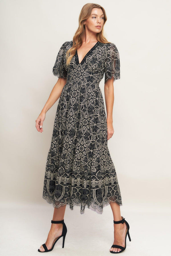 A woven lace midi dress featuring V neckline with lace trim, short sleeve, waist yoke and back zipper closure