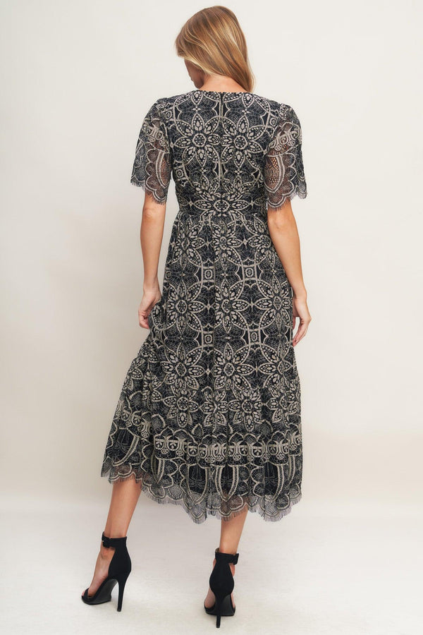 A woven lace midi dress featuring V neckline with lace trim, short sleeve, waist yoke and back zipper closure