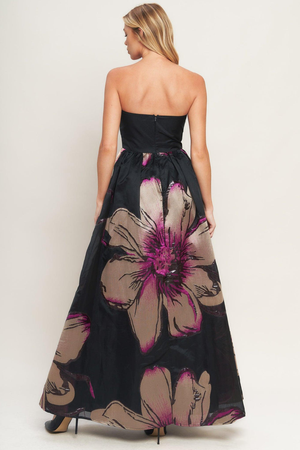 A solid and printed woven maxi dress featuring solid tube top, printed full skirt and back zipper closure