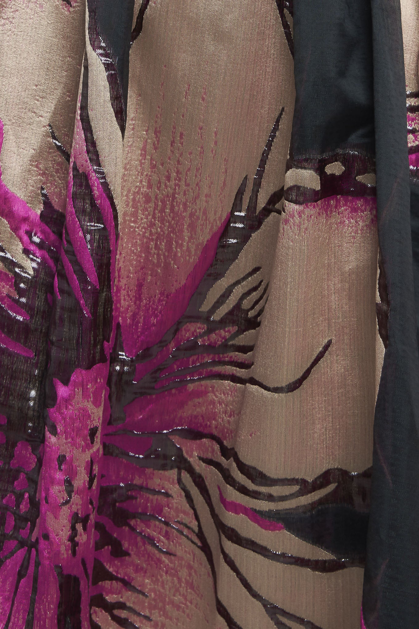 A solid and printed woven maxi dress featuring solid tube top, printed full skirt and back zipper closure