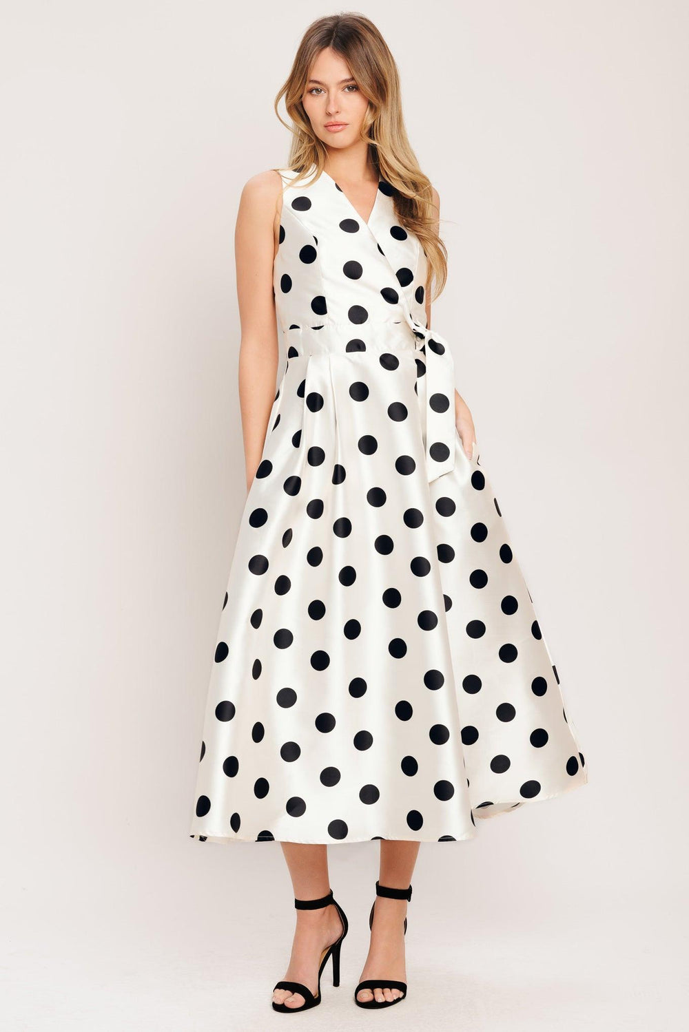 A printed woven midi dress featuring surplice neckline, sleeveless, side tie, full skirt and back zipper closure

Details:

Self: 100% Polyester

Lining: 100% Polyester

Size & Fit

-Model is 5`8" And Wearing Size Small
-Measurements Taken From Size Small
-Approx. Length: 51"