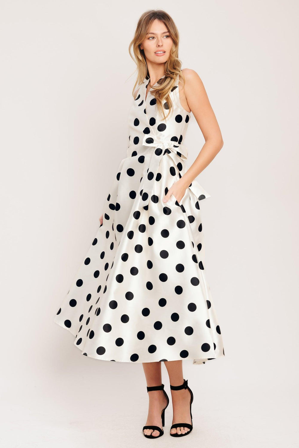A printed woven midi dress featuring surplice neckline, sleeveless, side tie, full skirt and back zipper closure

Details:

Self: 100% Polyester

Lining: 100% Polyester

Size & Fit

-Model is 5`8" And Wearing Size Small
-Measurements Taken From Size Small
-Approx. Length: 51"