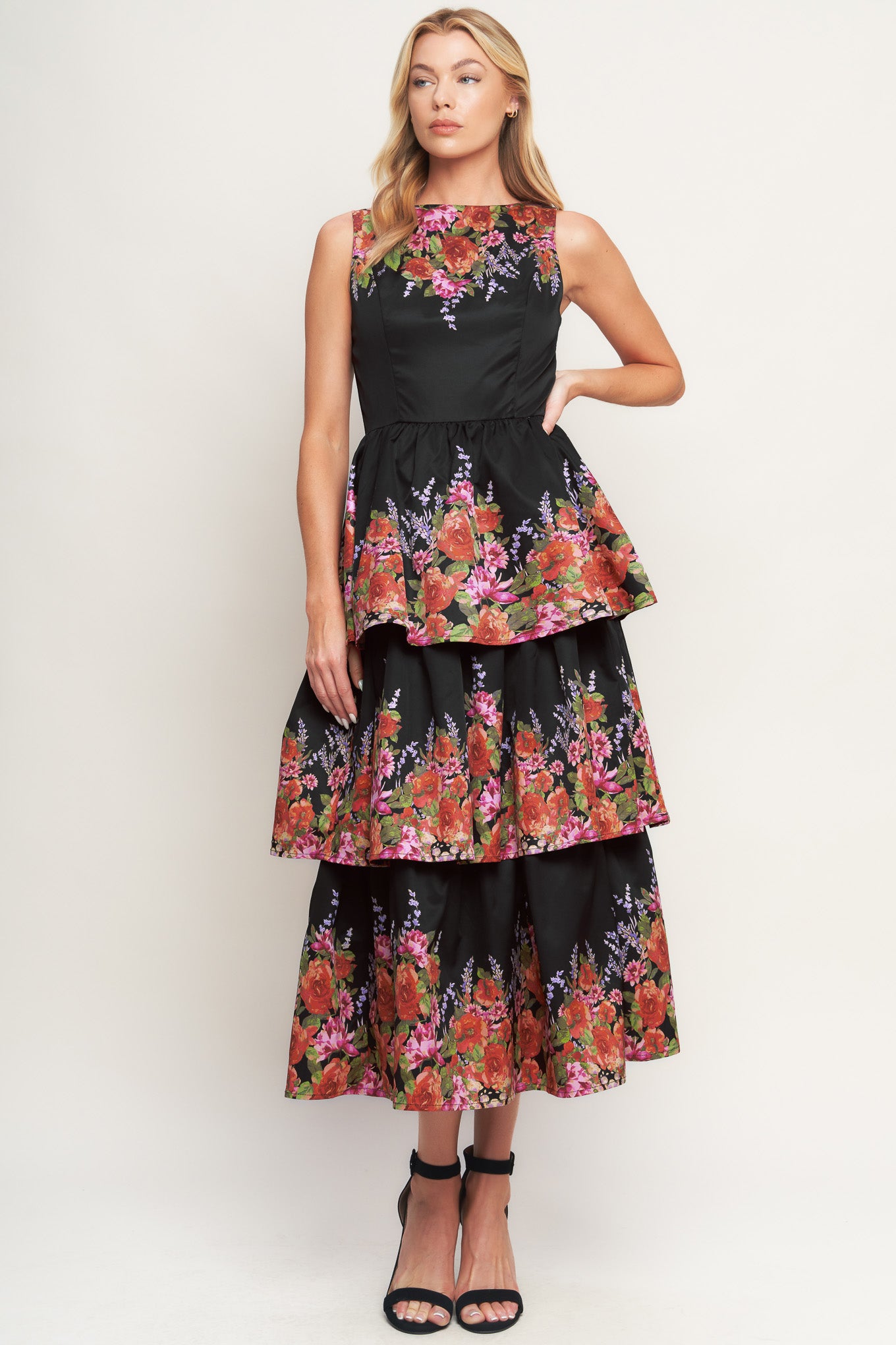 A printed woven midi dress featuring wide neckline, sleeveless, layered skirt and back zipper closure