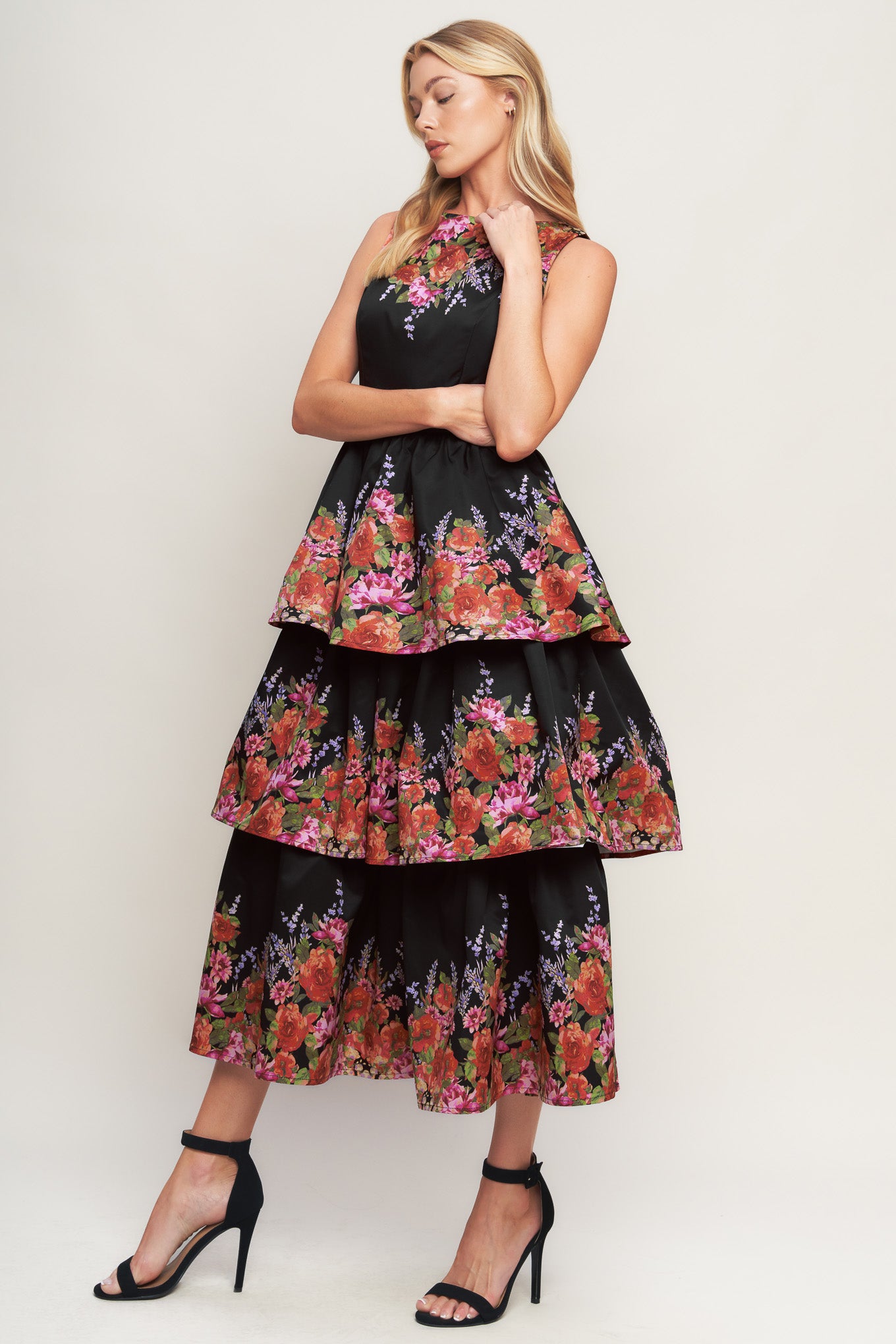 A printed woven midi dress featuring wide neckline, sleeveless, layered skirt and back zipper closure