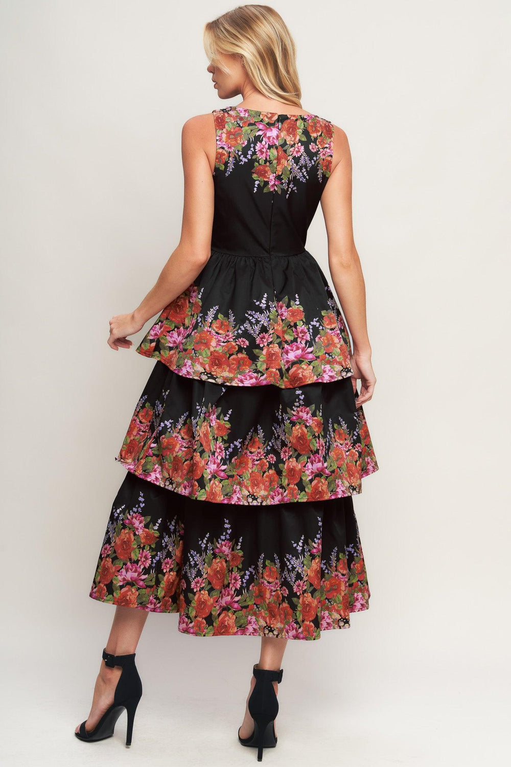 A printed woven midi dress featuring wide neckline, sleeveless, layered skirt and back zipper closure