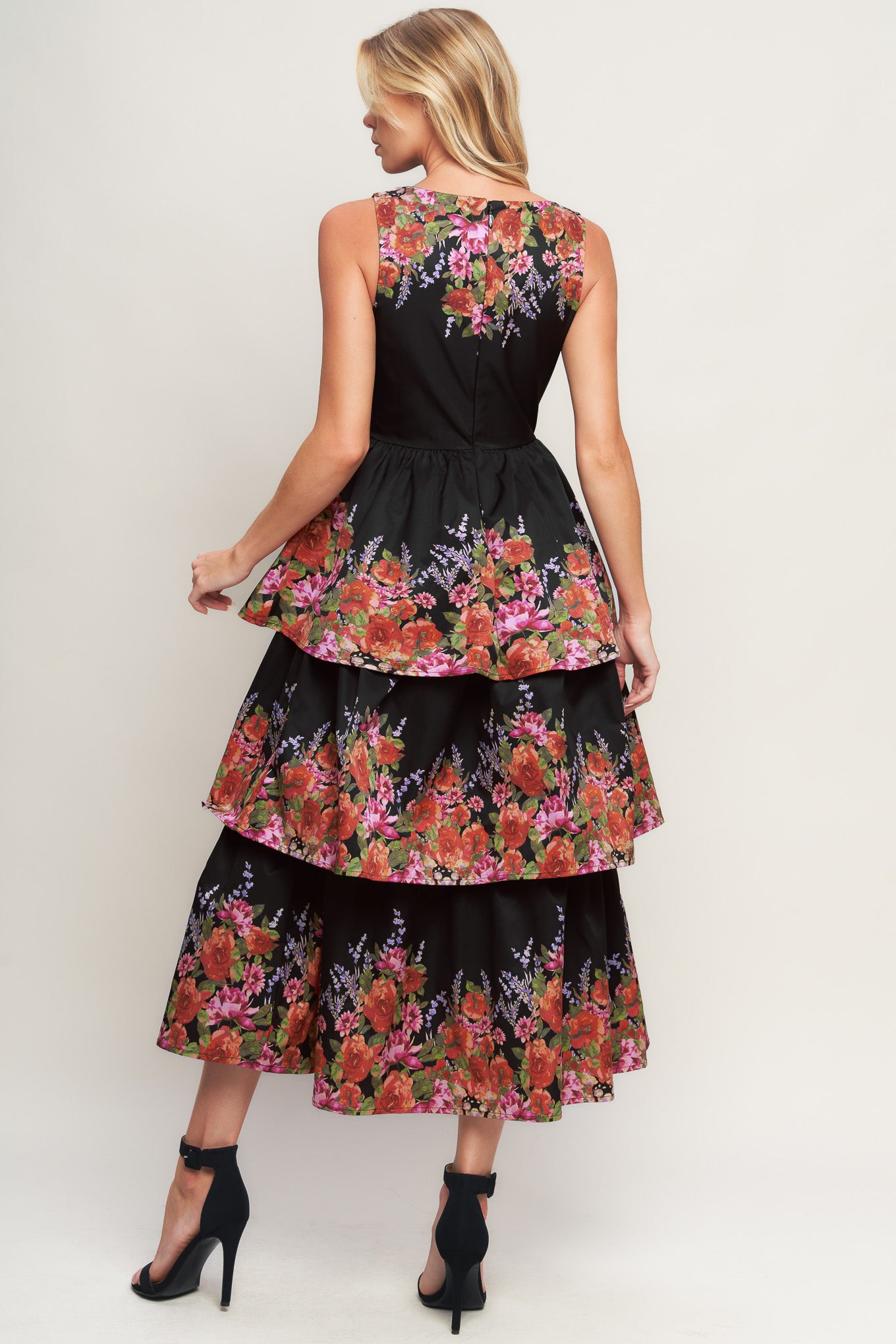 A printed woven midi dress featuring wide neckline, sleeveless, layered skirt and back zipper closure