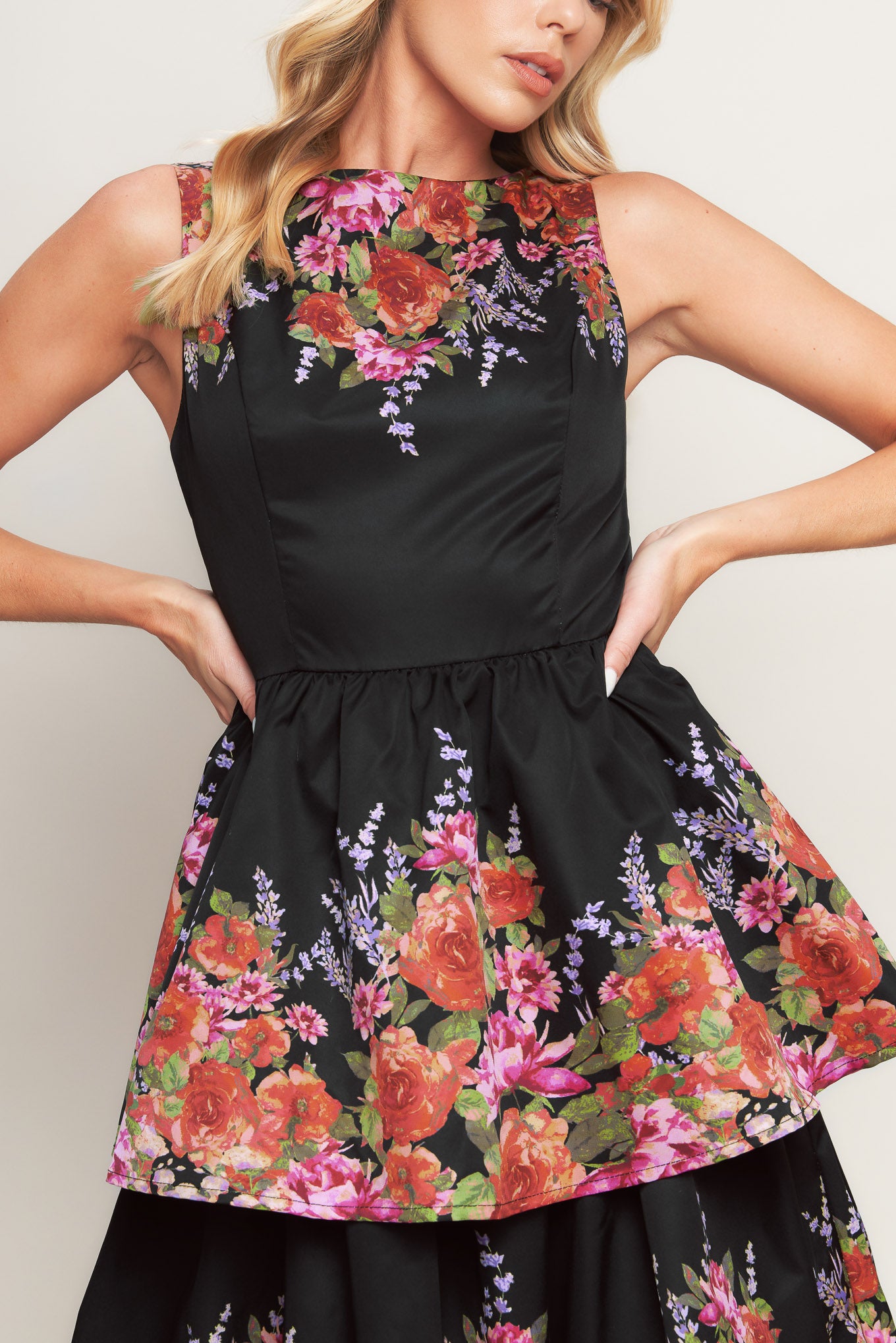A printed woven midi dress featuring wide neckline, sleeveless, layered skirt and back zipper closure