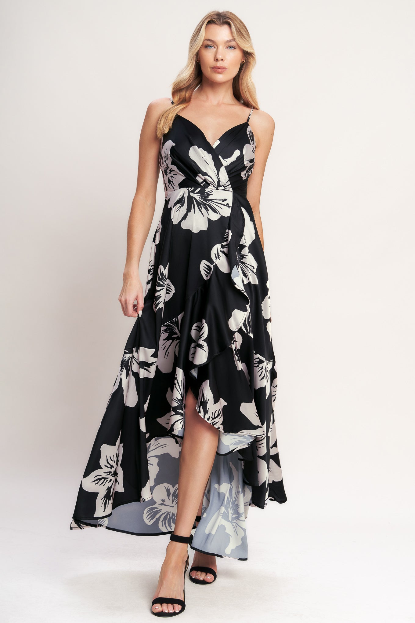 A printed woven maxi dress featuring surplice cami top, faux wrap with ruffle hem and back zipper closure

Details:

Self: 100% Polyester
Lining: 100% Polyester

Size & Fit

- Model is 5`8" And Wearing Size Small
- Measurements Taken From Size Small
- Approx. Length: 59"
