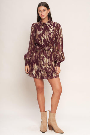 A metallic threaded woven mini dress featuring collar, bow tie, front button down and long sleeve with cuff