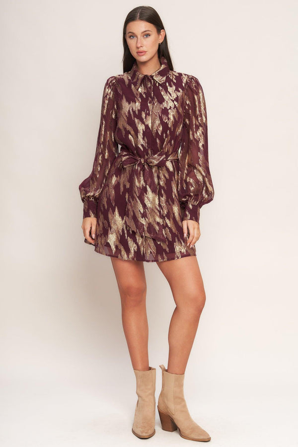 A metallic threaded woven mini dress featuring collar, bow tie, front button down and long sleeve with cuff