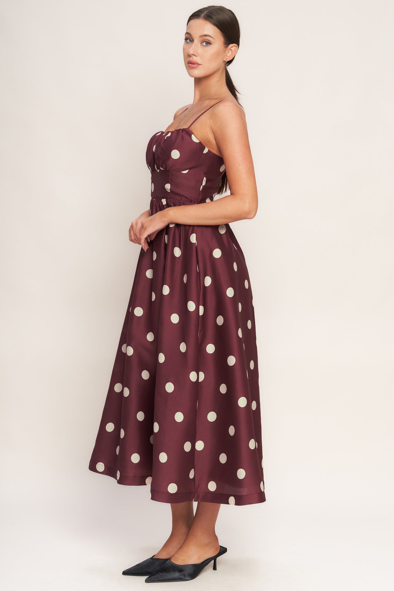 A printed woven midi dress featuring straight neckline, straps, shirred bodice, wide waist band, full skirt and back zipper closure