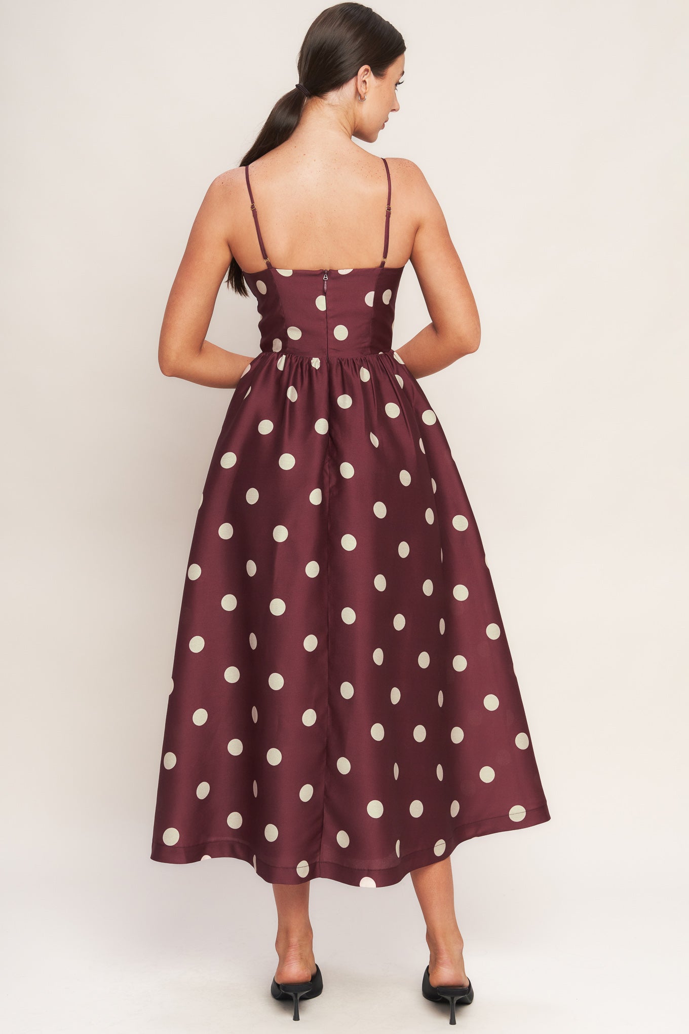 A printed woven midi dress featuring straight neckline, straps, shirred bodice, wide waist band, full skirt and back zipper closure