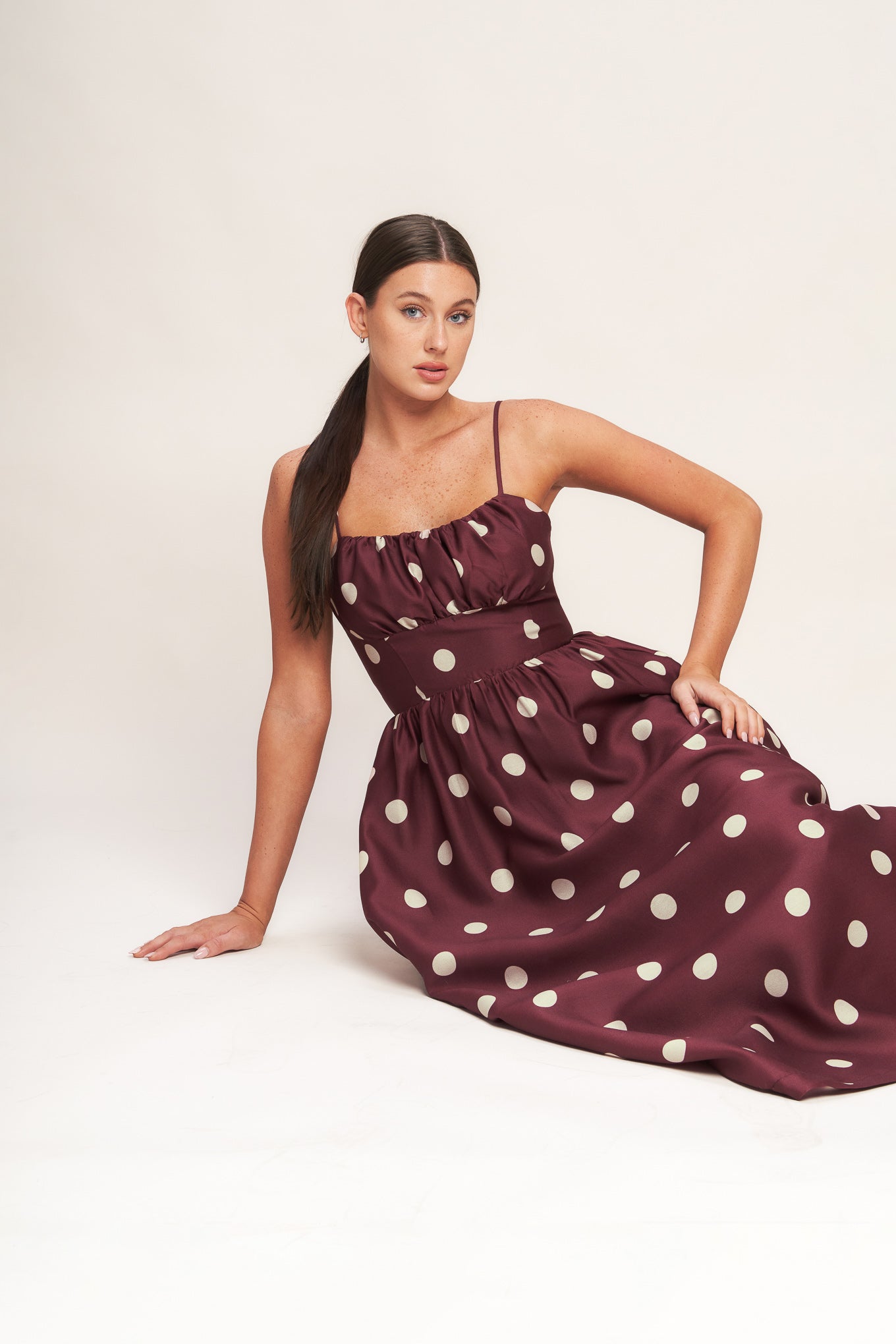 A printed woven midi dress featuring straight neckline, straps, shirred bodice, wide waist band, full skirt and back zipper closure