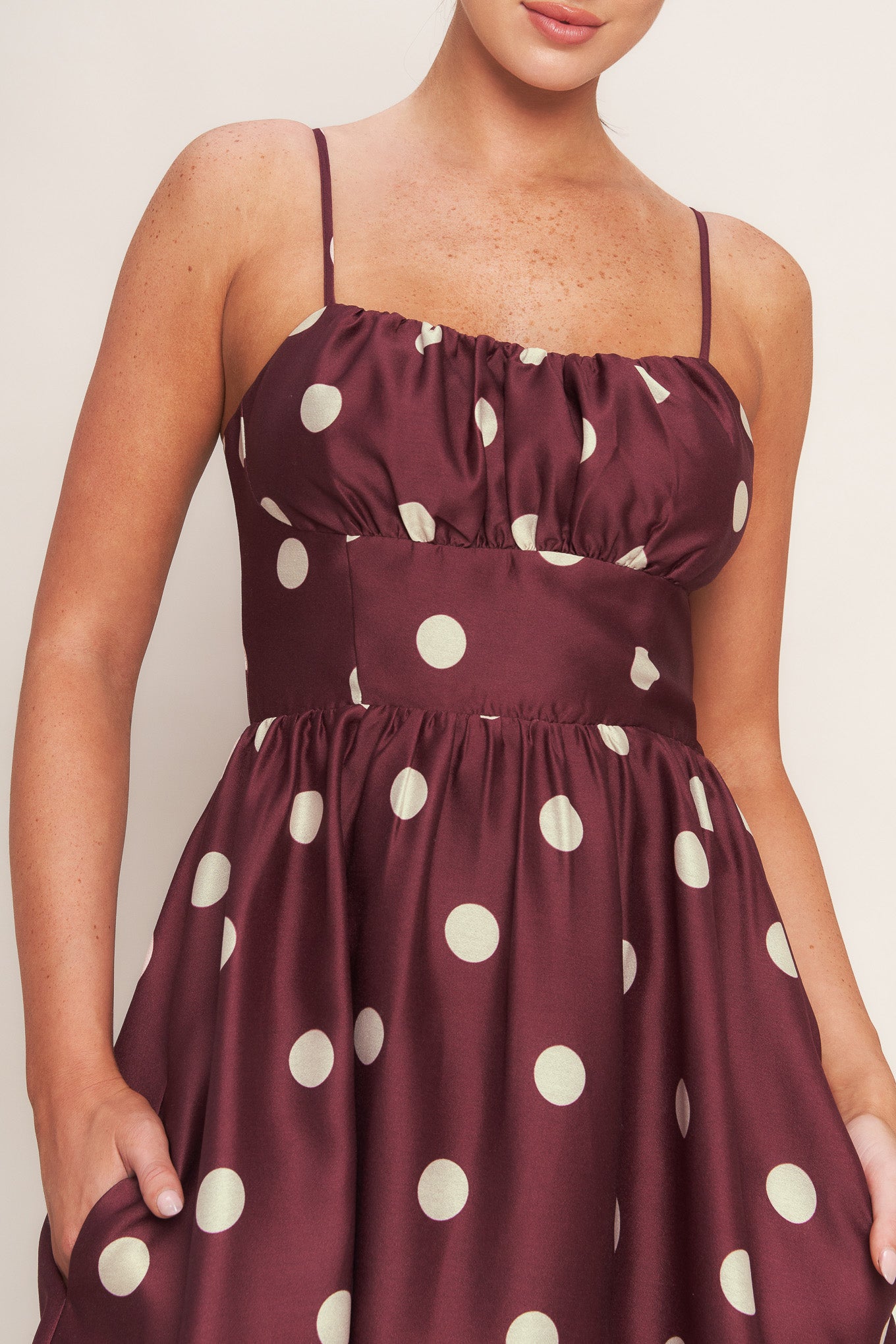 A printed woven midi dress featuring straight neckline, straps, shirred bodice, wide waist band, full skirt and back zipper closure