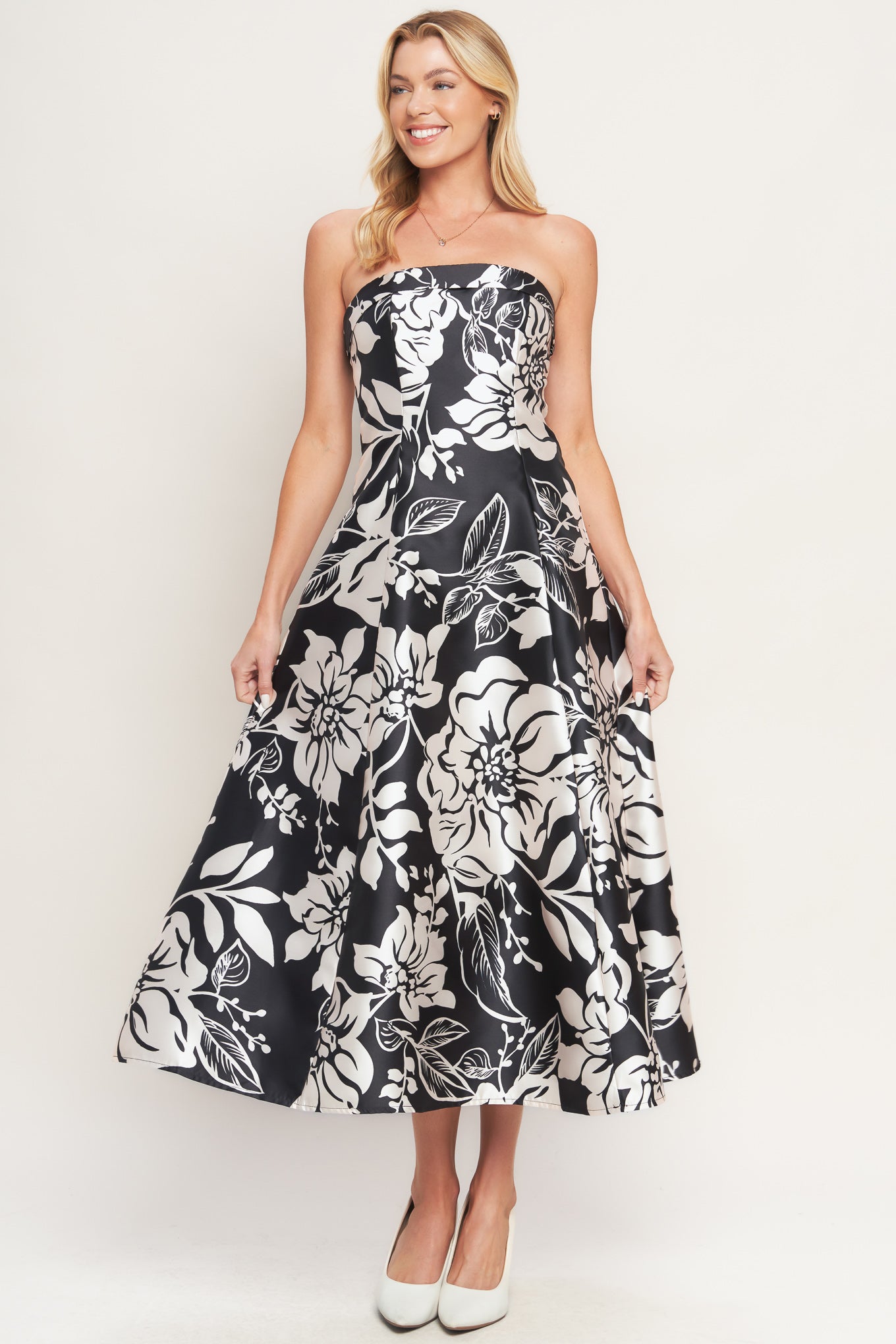 A printed woven midi dress featuring straight neckline, circle skirt and back zipper closure