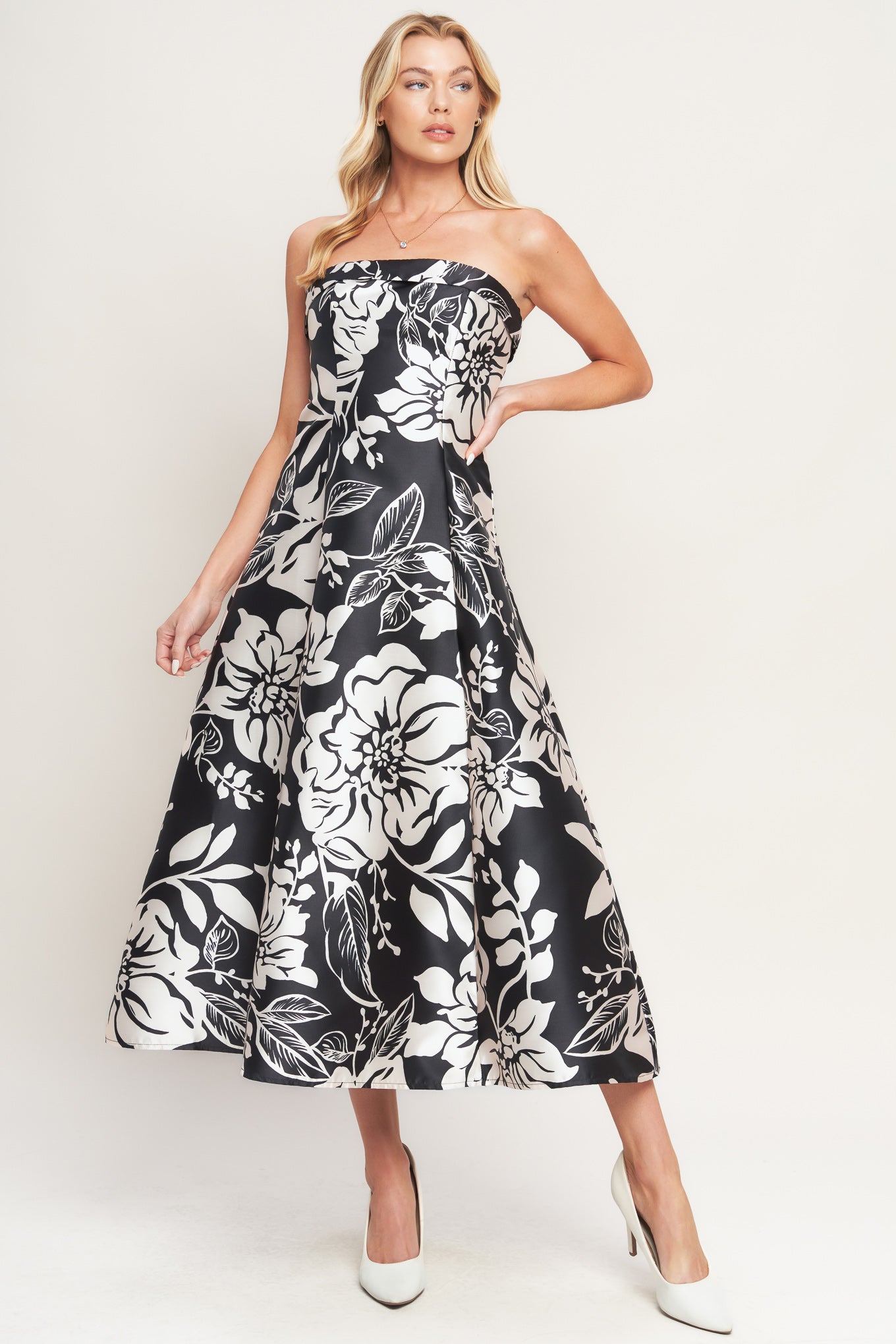 A printed woven midi dress featuring straight neckline, circle skirt and back zipper closure