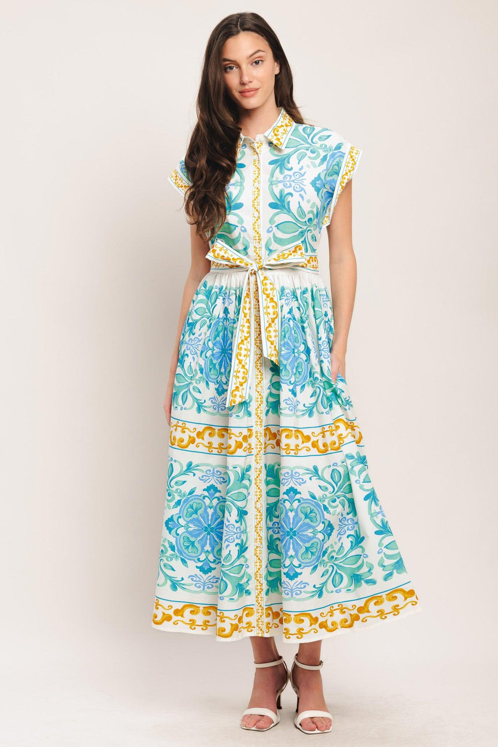 A printed woven midi dress featuring collar, short sleeve, front button down, self sash tie and full skirt

Details:

Self: 100% Cotton

Size & Fit

-Model is 5`8" And Wearing Size Small
-Measurements Taken From Size Small
-Approx. Length: 51"