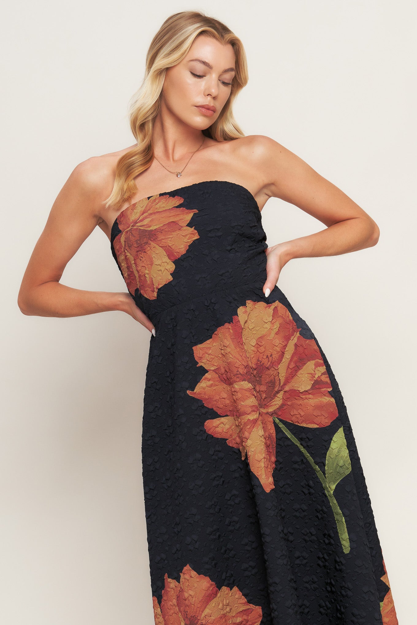A printed textured woven midi dress featuring strapless, circle skirt and back zipper closure