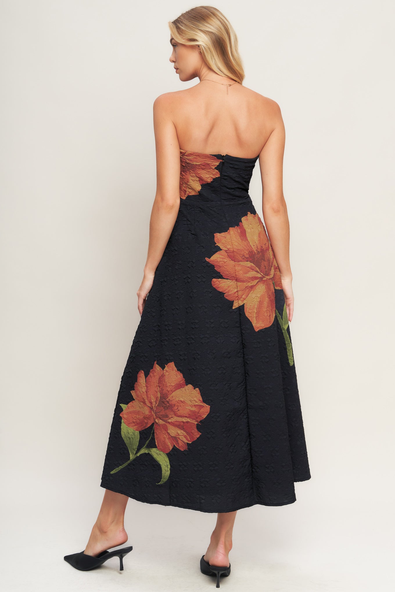 A printed textured woven midi dress featuring strapless, circle skirt and back zipper closure