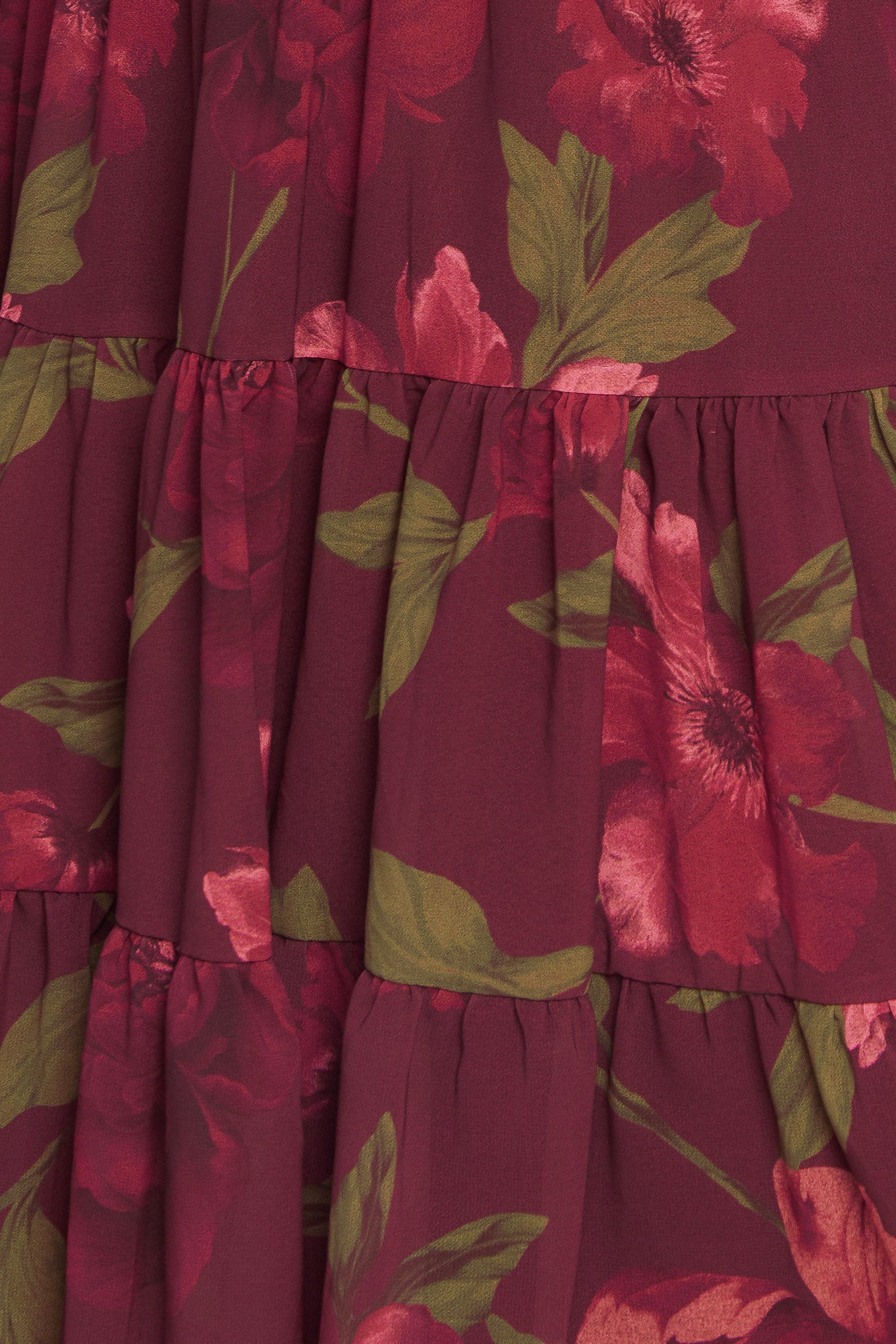 A printed woven mini dress featuring U neckline, smocked bodice, long sleeve with ruffled cuff and tiered skirt