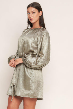 A foiled woven mini dress featuring round neckline, long sleeve, self sash tie and back neck button closure