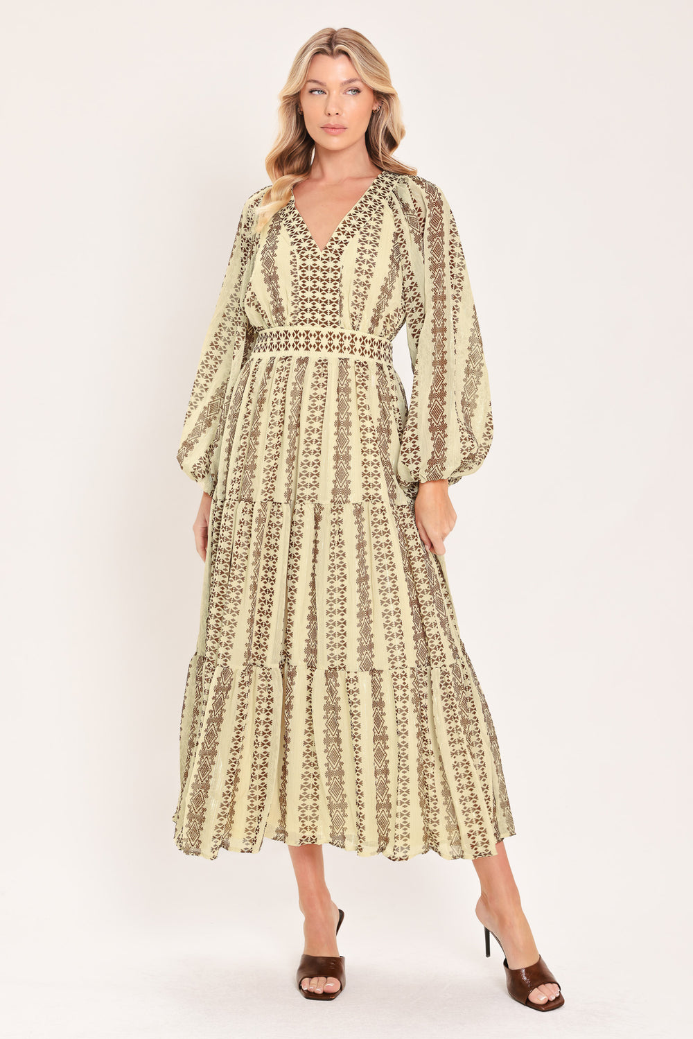 A woman modeling a long-sleeve midi dress with a beige and brown geometric pattern | Flying Tomato