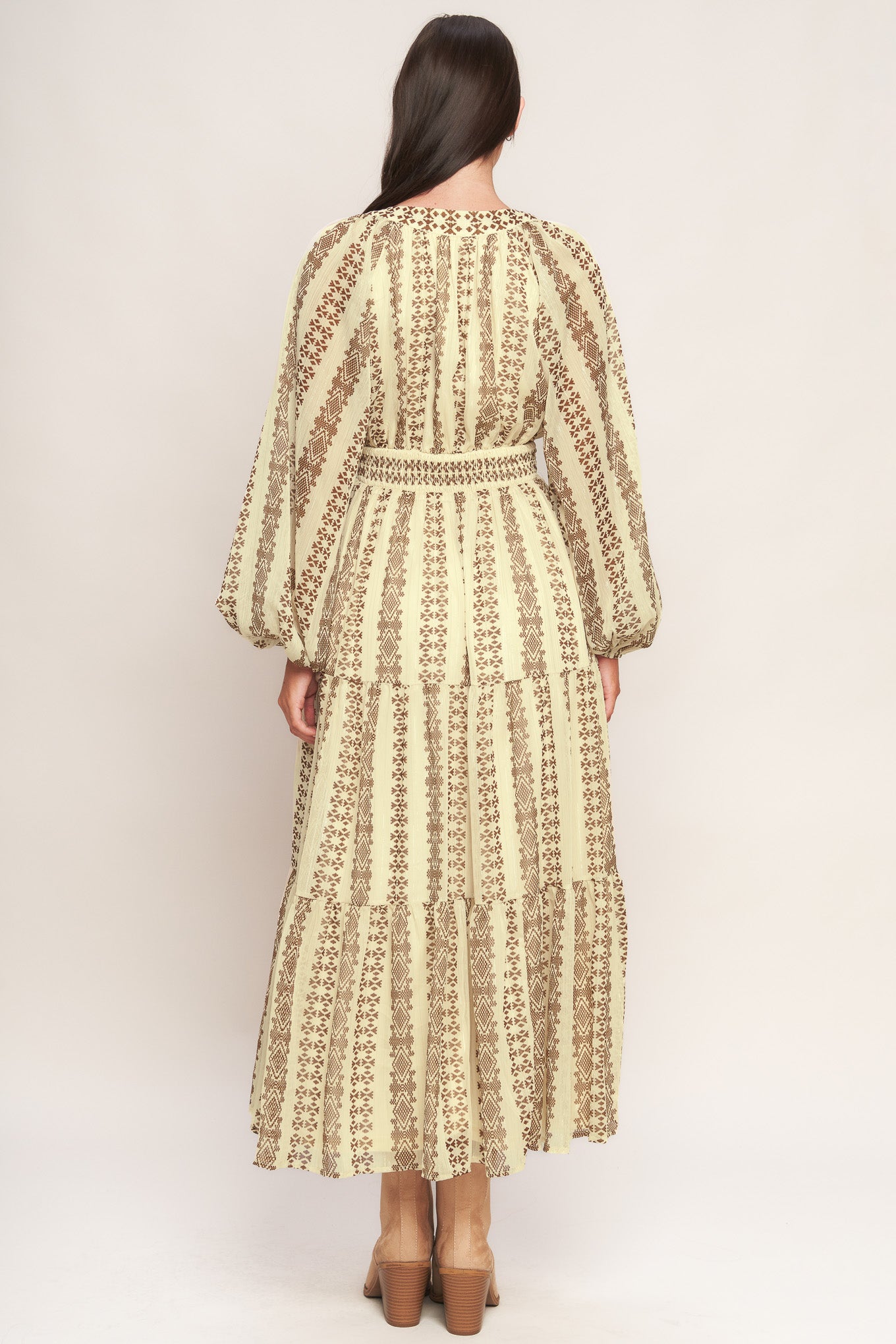 A printed metallic threaded woven midi dress featuring V neckline, long sleeve, tiered skirt and smocked back waist band