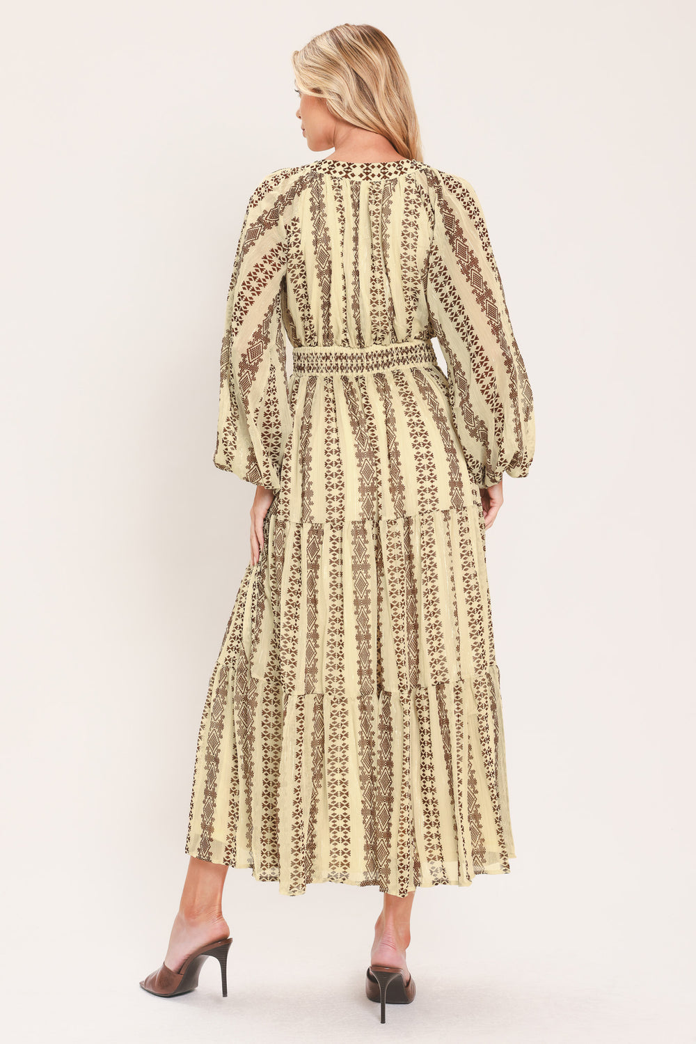 A woman modeling a long-sleeve midi dress with a beige and brown geometric pattern | Flying Tomato
